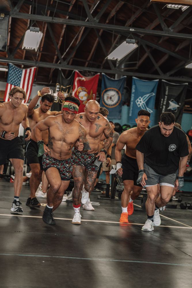 Men's heat starts a workout under the service flags at CrossFit Fortius