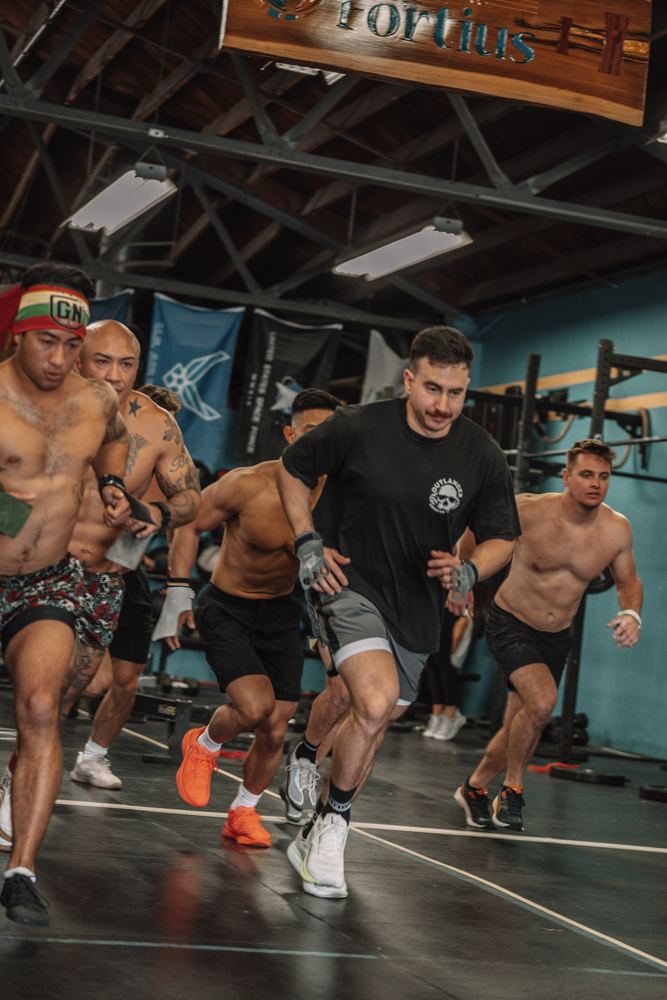 Men's heat breaks from the start line under the CrossFit Fortius sign