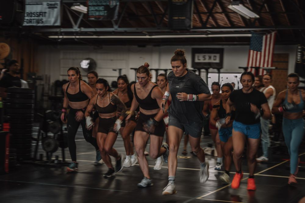 Women's heat sprints off the start line at CrossFit Fortius